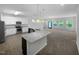Open-concept kitchen with stainless steel appliances, granite countertops, and abundant natural light at 136 W Tecoma Ln, Clayton, NC 27520