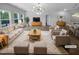 Bright living room featuring stylish furniture, neutral tones, and modern chandelier at 136 W Tecoma Ln, Clayton, NC 27520
