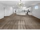 Large living room with hardwood flooring, plenty of natural light, and an open layout into the kitchen at 136 W Tecoma Ln, Clayton, NC 27520