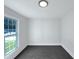 Bright bedroom with fresh paint, new carpeting, and natural light from the large window at 1405 Cross Link Rd, Raleigh, NC 27610