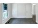 Bright bedroom with fresh paint, new carpeting, and natural light from the large window at 1405 Cross Link Rd, Raleigh, NC 27610