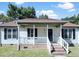 Charming home with a cozy covered front porch, brick stairs, and black shutters at 1405 Cross Link Rd, Raleigh, NC 27610