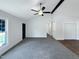 Spacious living room with high ceilings, fresh paint, new carpeting, and an oversized fan at 1405 Cross Link Rd, Raleigh, NC 27610