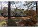 Large backyard featuring mature landscaping and detached outbuilding at 1408 Edgebrook Dr, Garner, NC 27529