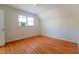 Comfortable bedroom with wood floors, white walls, and a window air conditioning unit at 1408 Edgebrook Dr, Garner, NC 27529