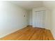 Bedroom with hardwood floors, white walls, and bi-fold closet doors at 1408 Edgebrook Dr, Garner, NC 27529