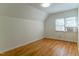 This bedroom has hardwood floors, white walls, and a window unit at 1408 Edgebrook Dr, Garner, NC 27529