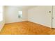Empty bedroom with parquet floors, white walls, and a single window at 1408 Edgebrook Dr, Garner, NC 27529