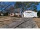 Brick home with a long driveway leading to a detached garage at 1408 Edgebrook Dr, Garner, NC 27529