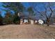 Brick house with a detached garage set on a grassy lawn at 1408 Edgebrook Dr, Garner, NC 27529