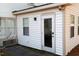 Side of home features convenient access door, utility connections, and clean exterior at 1408 Edgebrook Dr, Garner, NC 27529