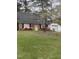 Charming brick home featuring blooming pink azaleas and a detached garage at 1408 Edgebrook Dr, Garner, NC 27529