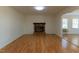 Cozy living room featuring a brick fireplace and abundant natural light at 1408 Edgebrook Dr, Garner, NC 27529