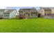 Spacious backyard with a large green lawn and wooden deck perfect for gatherings and outdoor activities at 144 Cobble Ridge Dr, Pittsboro, NC 27312