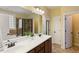 Bathroom vanity featuring double sinks, a large mirror, and decorative lighting at 144 Cobble Ridge Dr, Pittsboro, NC 27312