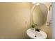 Powder room with a pedestal sink and round mirror at 144 Cobble Ridge Dr, Pittsboro, NC 27312