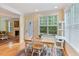 Bright dining area with natural light, views of greenery, and seating for four at 144 Cobble Ridge Dr, Pittsboro, NC 27312