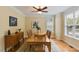 Bright dining room boasting hardwood floors, large windows, and a ceiling fan at 144 Cobble Ridge Dr, Pittsboro, NC 27312