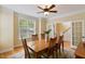 Bright dining room boasting hardwood floors, large windows, and a ceiling fan at 144 Cobble Ridge Dr, Pittsboro, NC 27312