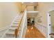 Bright foyer showcasing hardwood floors, staircase, and entry to the living room at 144 Cobble Ridge Dr, Pittsboro, NC 27312