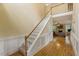 Bright foyer showcasing hardwood floors, staircase, and entry to the living room at 144 Cobble Ridge Dr, Pittsboro, NC 27312