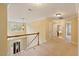 Upstairs hallway with natural light, carpet, and doors leading to bedrooms at 144 Cobble Ridge Dr, Pittsboro, NC 27312