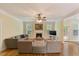 Inviting living room with hardwood floors, cozy fireplace, and large windows at 144 Cobble Ridge Dr, Pittsboro, NC 27312