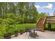 Charming patio and spacious backyard setting with lush trees at 144 Cobble Ridge Dr, Pittsboro, NC 27312