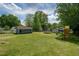 Generous backyard showing a shed, trampoline, swing set, and lush greenery, for endless outdoor possibilities at 1542 Albright Ave, Burlington, NC 27215