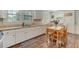 Bright kitchen with dining area features white cabinetry, modern appliances, and hardwood flooring at 1542 Albright Ave, Burlington, NC 27215