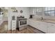 Bright kitchen featuring stainless steel appliances, ample counter space, and updated flooring at 1542 Albright Ave, Burlington, NC 27215