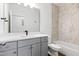 Bathroom with gray vanity, marble-look shower and tub, and natural light at 157 Maplewood Dr, Sanford, NC 27332