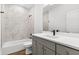Modern bathroom featuring a gray vanity, a white countertop, and a shower and tub at 157 Maplewood Dr, Sanford, NC 27332