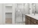 Bright bathroom featuring a glass shower with marble tile and an attached walk-in closet at 157 Maplewood Dr, Sanford, NC 27332