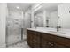 Bathroom featuring a double vanity, a modern shower, and a white, gray, and brown color scheme at 157 Maplewood Dr, Sanford, NC 27332