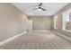 Large bedroom with three large windows, carpet, and a ceiling fan at 157 Maplewood Dr, Sanford, NC 27332
