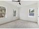 Well-lit bedroom with three windows and a ceiling fan at 157 Maplewood Dr, Sanford, NC 27332