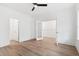 Bedroom featuring hardwood floors, an open doorway, and white trim at 157 Maplewood Dr, Sanford, NC 27332