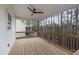 Spacious covered deck with ceiling fan and wood floors, perfect for outdoor entertaining at 157 Maplewood Dr, Sanford, NC 27332