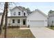 Charming two-story home with a welcoming front porch and attached two-car garage at 157 Maplewood Dr, Sanford, NC 27332