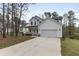 Well-manicured two-story home with a welcoming front porch and large driveway at 157 Maplewood Dr, Sanford, NC 27332