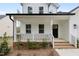 Inviting front porch of a charming home, featuring classic railing and brick steps at 157 Maplewood Dr, Sanford, NC 27332