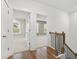 Second floor hallway featuring wood floors and railing, leading to multiple bedrooms at 157 Maplewood Dr, Sanford, NC 27332