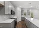 Bright kitchen boasts gray cabinets, quartz countertops, stainless appliances, and hardwood floors at 157 Maplewood Dr, Sanford, NC 27332