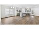 Open-concept kitchen with gray cabinets, stainless steel appliances, and wood flooring at 157 Maplewood Dr, Sanford, NC 27332
