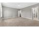 Spacious primary bedroom featuring neutral carpet, paint, and an ensuite bathroom entrance at 157 Maplewood Dr, Sanford, NC 27332