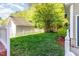 Beautiful backyard showing the lawn and the detached garage on a sunny day at 161 Fort Jackson Rd, Morrisville, NC 27560