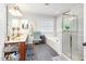 Bright bathroom with dual sinks, glass shower, and soaking tub at 161 Fort Jackson Rd, Morrisville, NC 27560