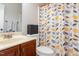 Cozy bathroom featuring a vanity with sink, toilet, and a decorative leaf-patterned shower curtain at 161 Fort Jackson Rd, Morrisville, NC 27560