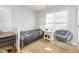 This bedroom features neutral colored walls, carpet, and a large window at 161 Fort Jackson Rd, Morrisville, NC 27560